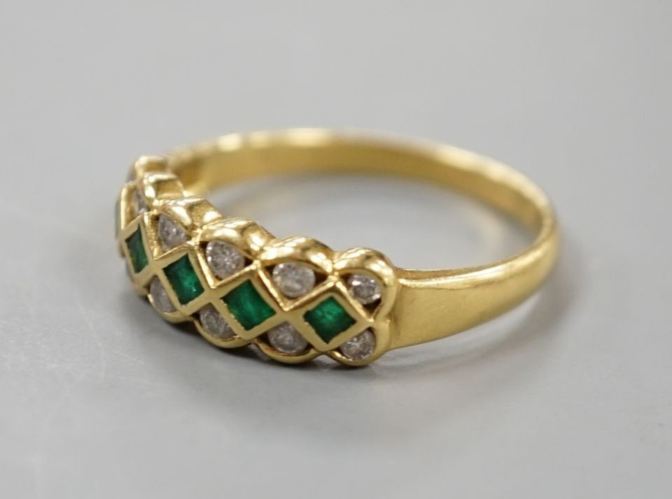 A modern 18ct gold, emerald and diamond line cluster set half hoop ring, size R, gross 3.9 grams.